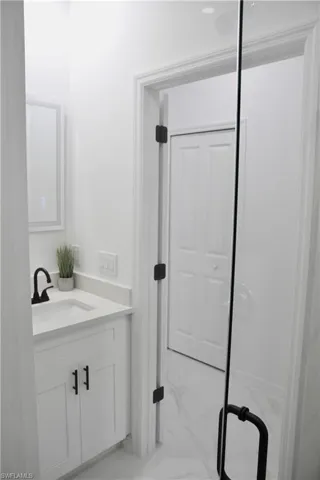 Bathroom with marble finish floor and vanity
