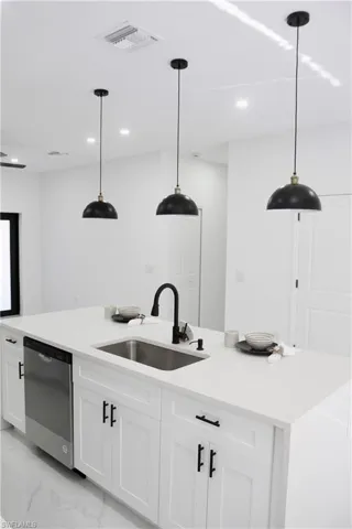 Bar with recessed lighting, a sink, visible vents, marble finish floor, and stainless steel dishwasher