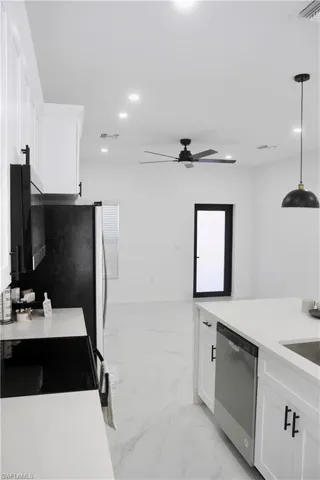 Kitchen with marble finish floor, recessed lighting, white cabinetry, dishwasher, and black / electric stove