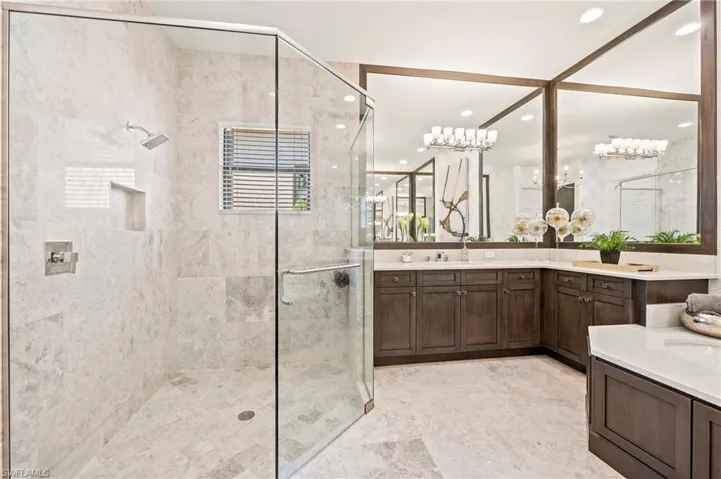 4056 Nova Ln. Naples FL 34119 - Owner's bath with mirrors to the ceiling walk in shower, and centerpiece soaking tub