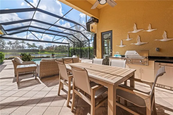 4056 Nova Ln. Naples FL 34119 - Lanai dining area with outdoor kitchen