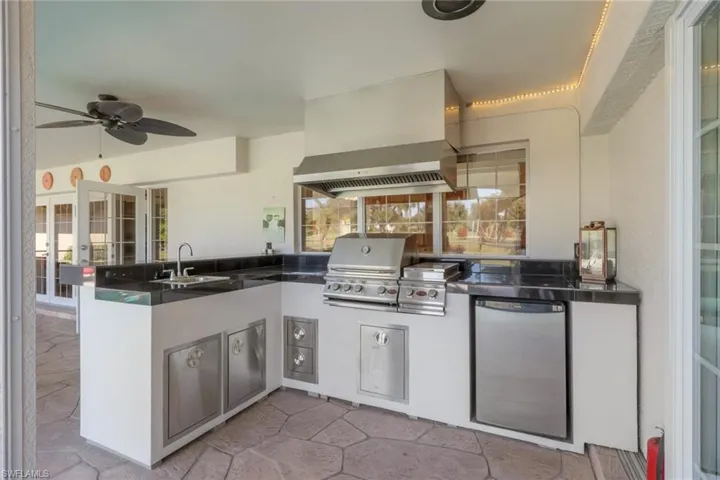 View of patio / terrace featuring a ceiling fan and an outdoor kitchen
