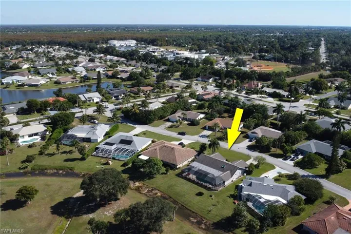 Aerial view of property's location with nearby suburban area and a large body of water