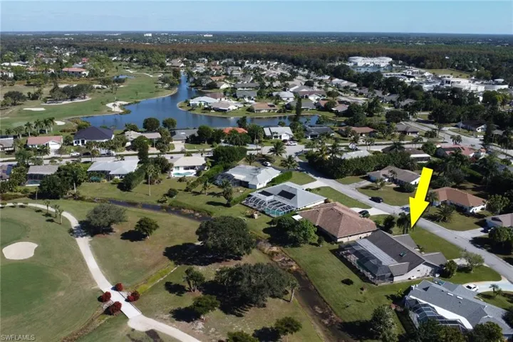 Aerial view of property's location with nearby suburban area and a nearby body of water