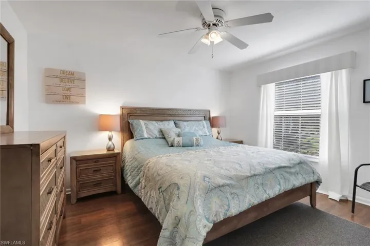 Bedroom with dark wood-style flooring and ceiling fan
