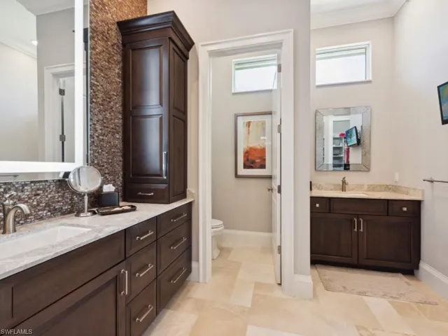 Bathroom with vanity, crown molding, toilet, and tile patterned floors