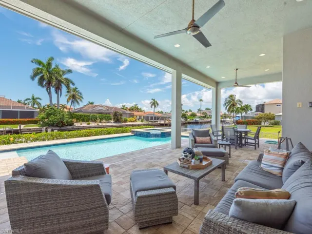 View of pool with a patio, an outdoor hangout area, and ceiling fan