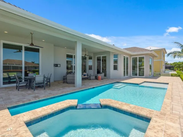 View of pool featuring ceiling fan and a patio area