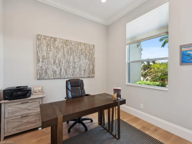 Office with crown molding and light wood-type flooring