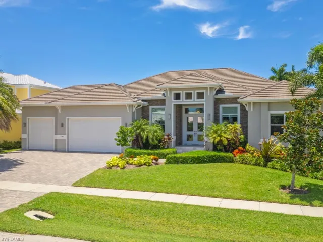 Prairie-style home with a garage and a front lawn