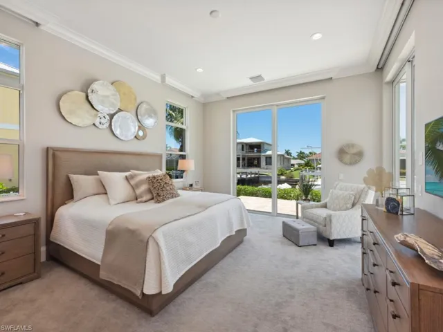 Carpeted bedroom featuring access to outside, crown molding, and multiple windows