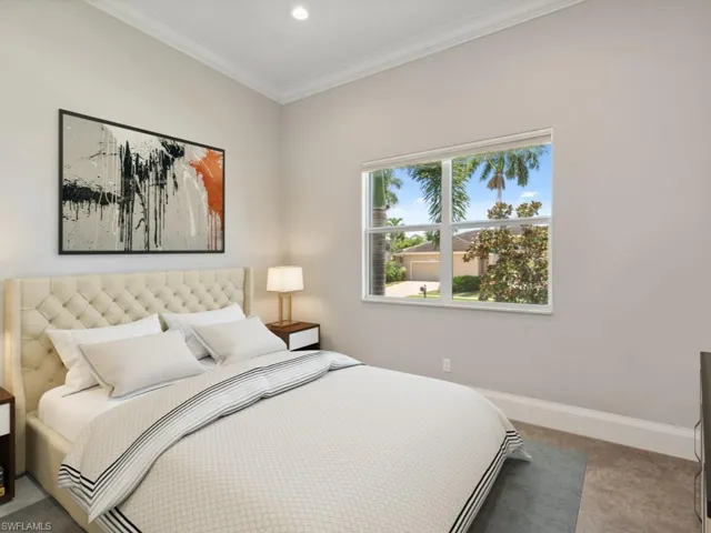Bedroom with ornamental molding and carpet flooring