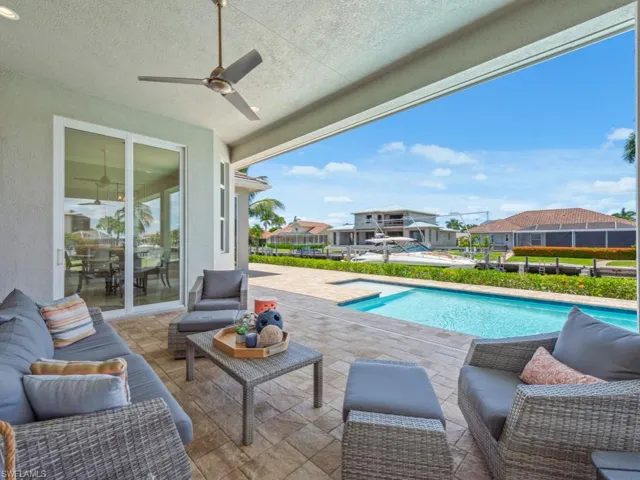 View of swimming pool featuring outdoor lounge area, ceiling fan, and a patio area