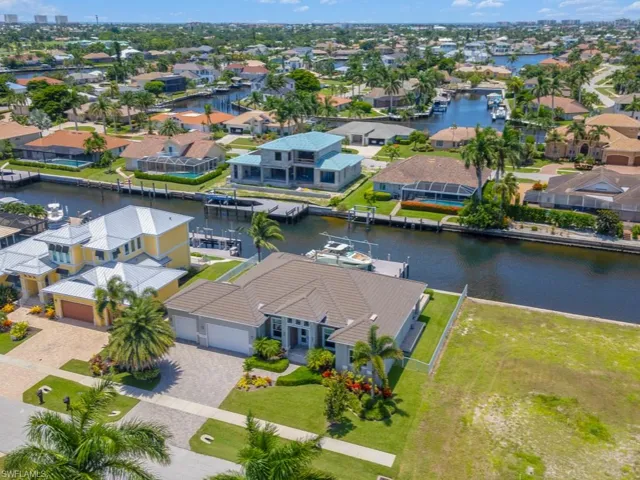 Birds eye view of property with a water view