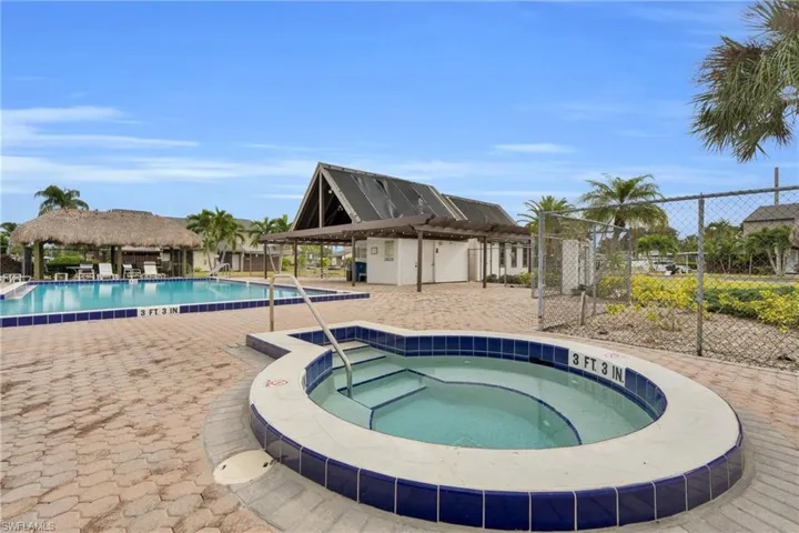 Community pool featuring a hot tub and a patio area