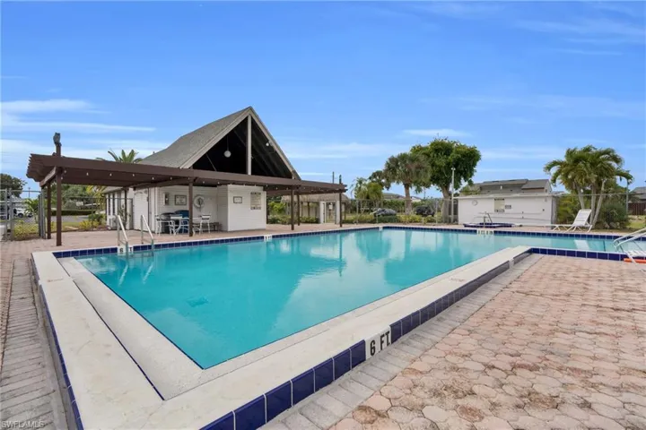 Community pool with a patio