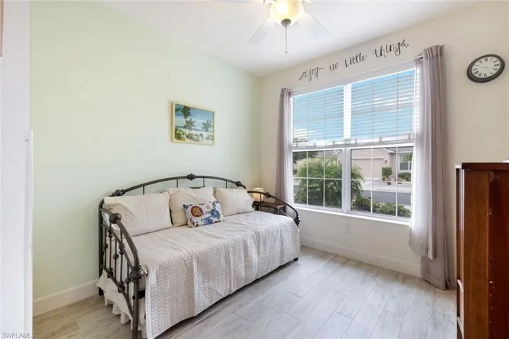 Bedroom with light wood-style floors and a ceiling fan