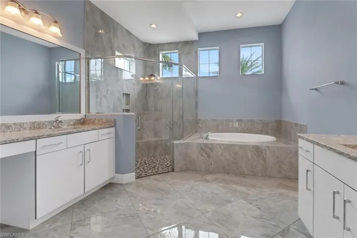 Master bedroom with separate tub and shower and dual sinks