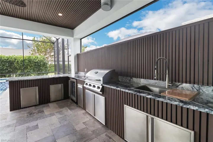 This amazing outdoor kitchen and bar was just completed and has never been used!