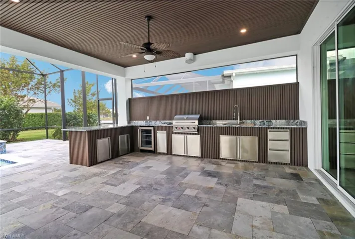 Additional covered lanai space offers outdoor living, dining, kitchen and bar areas.