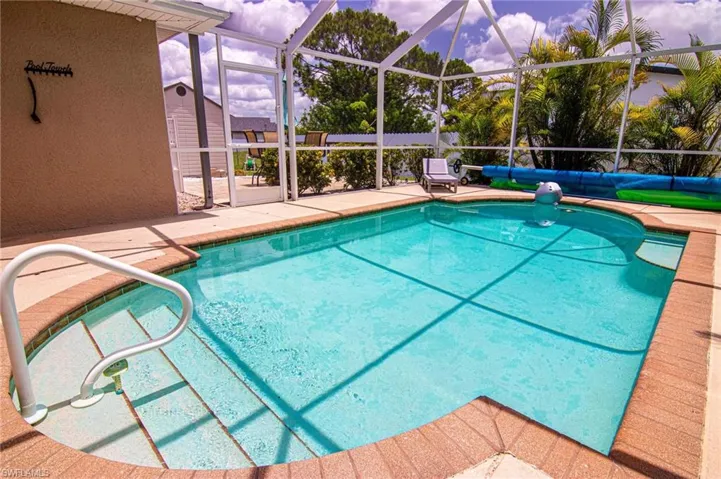 Swimming pool with a patio and a lanai