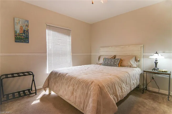 Carpeted bedroom featuring baseboards