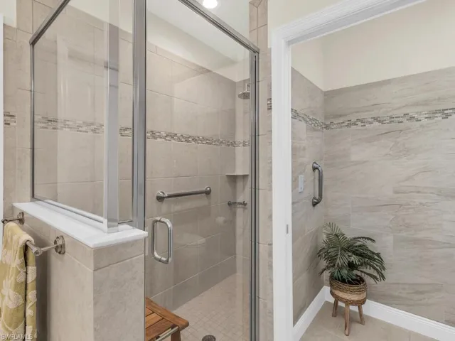 Bathroom with tile patterned floors and walk in shower