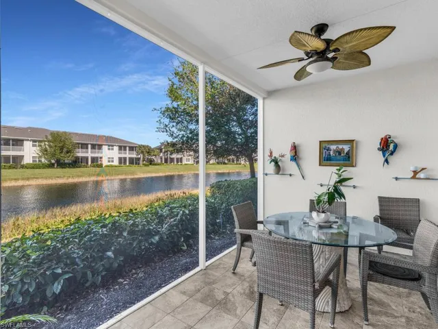 Sunroom featuring ceiling fan, a healthy amount of sunlight, and a water view