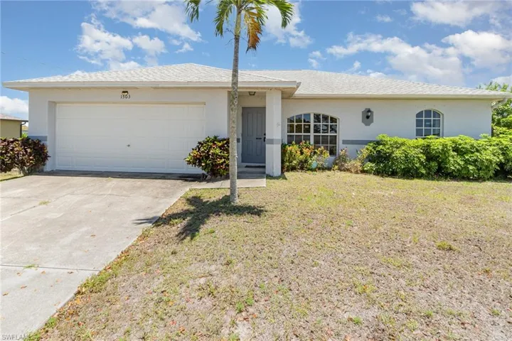 Single story home with a garage, stucco siding, concrete driveway, and a front yard