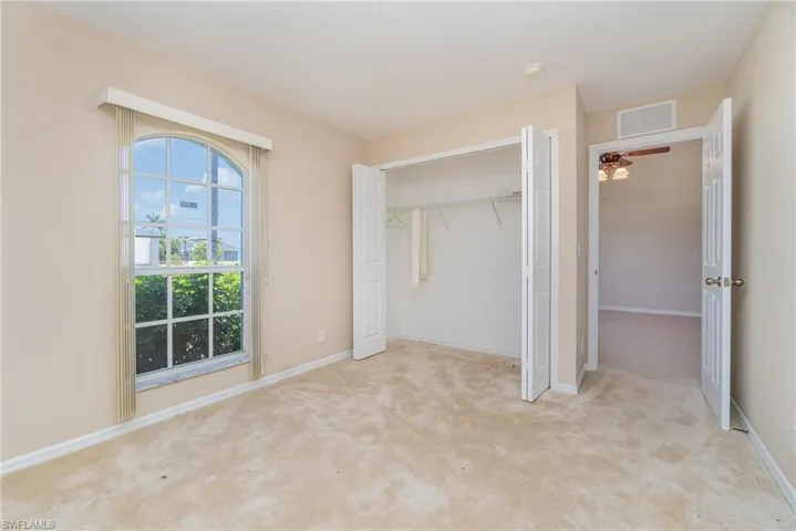 bedroom featuring carpet, baseboards, and a closet