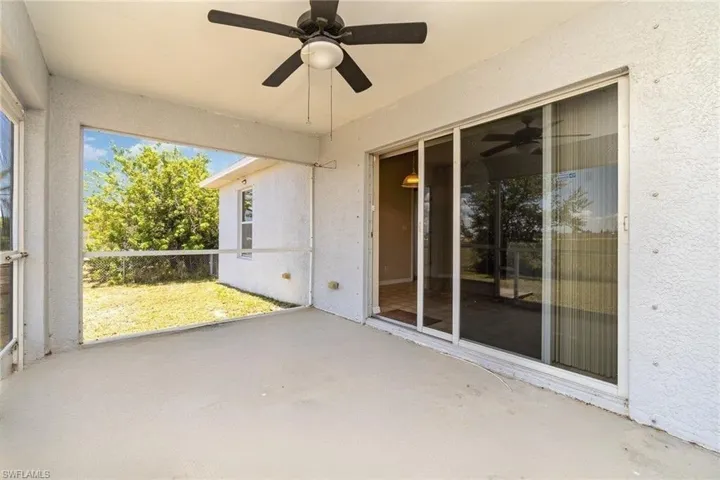 Unfurnished sunroom featuring ceiling fan