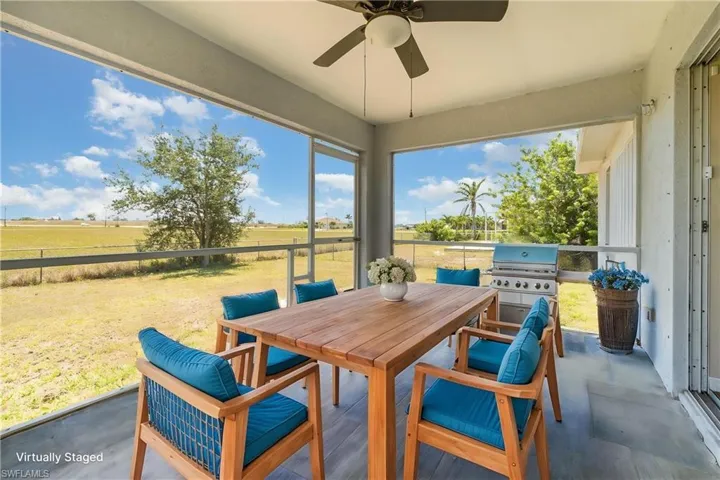 Sunroom / solarium with outdoor dining area, ceiling fan, and a view of rural / pastoral area