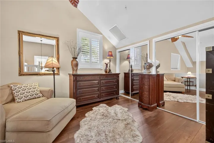 Primary Bedroom Living area featuring wood finished floors and vaulted ceiling
