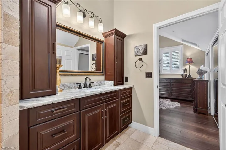 Bathroom with vanity and vaulted ceiling