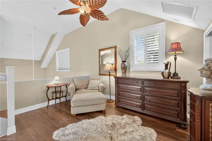 Primary Bedroom Living area featuring vaulted ceiling, dark wood finished floors, and ceiling fan
