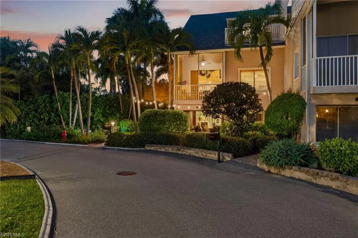 View of property at dusk