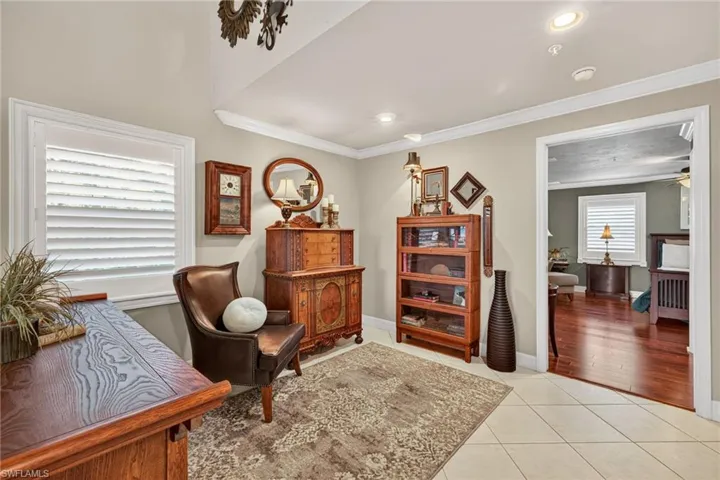 Sitting room with light tile patterned floors, crown molding, recessed lighting, and a ceiling fan
