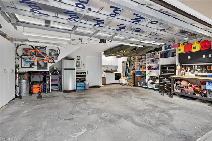 Garage with washer / dryer and freestanding refrigerator