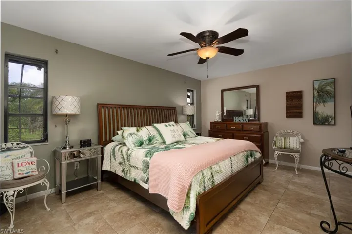 Bedroom featuring baseboards and ceiling fan