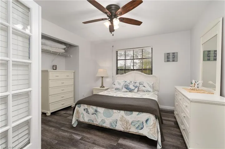 Bedroom featuring dark wood-style floors and a ceiling fan