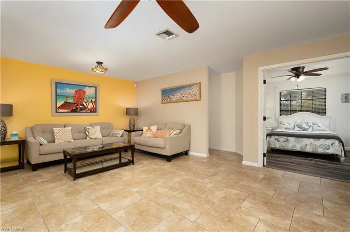 Living room with a ceiling fan and baseboards