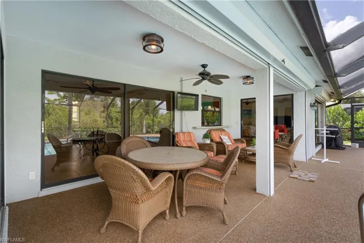 Sunroom featuring a ceiling fan and outdoor dining area