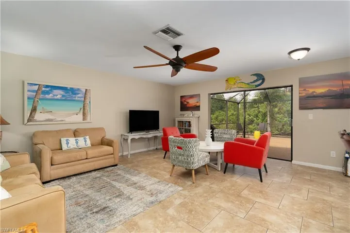Living area with baseboards and a ceiling fan