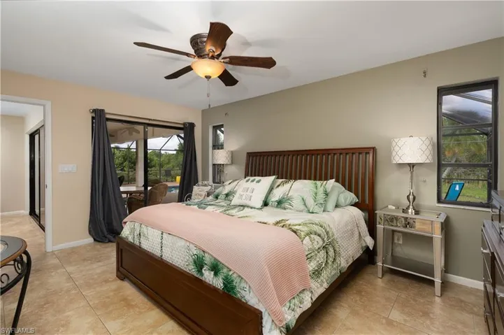 Bedroom featuring access to outside, a ceiling fan, baseboards, and light tile patterned flooring