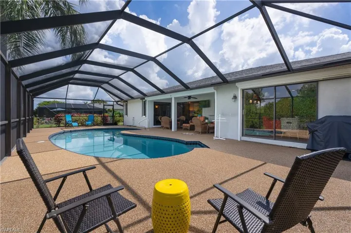 Swimming pool with a patio, a ceiling fan, area for grilling, and a lanai