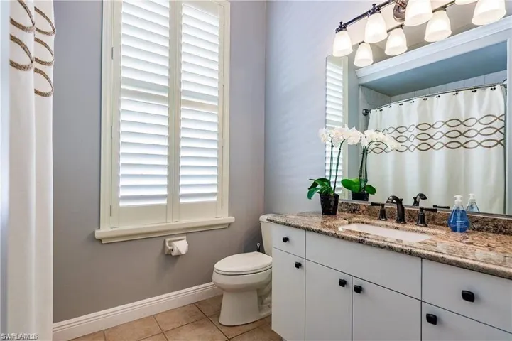 bathroom 3 Full hall bathroom featuring vanity, a shower with curtain, and light tile patterned floors