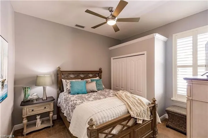 Bedroom 3 featuring carpet floors, a closet, and a ceiling fan