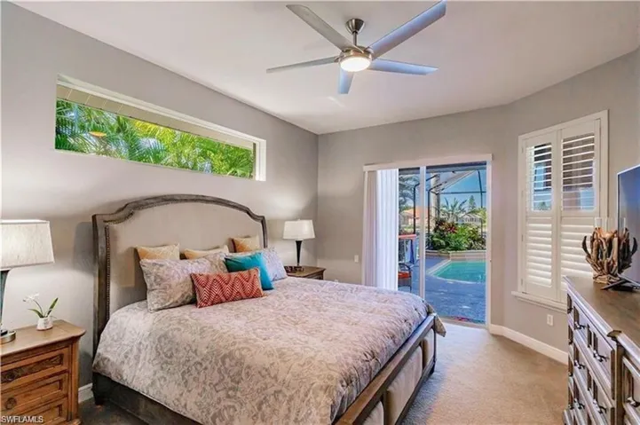 Bedroom with multiple windows, access to outside, ceiling fan, and carpet floors