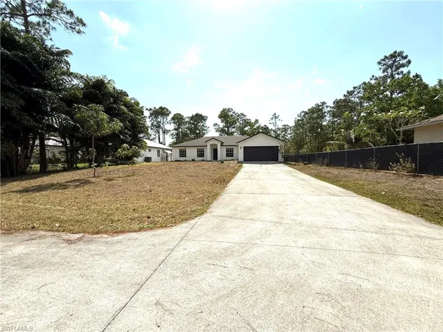 Ranch-style house featuring concrete driveway and a garage