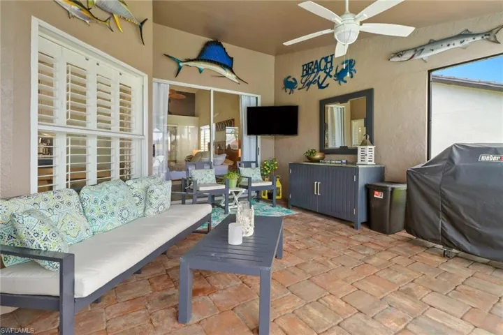 View of patio / terrace with ceiling fan, area for grilling, and an outdoor hangout area